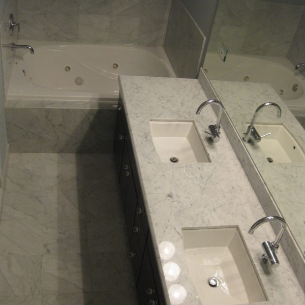 white marble bath tub and vanity